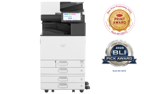 A front view of IM C3010(A) Ricoh office multifunction printer with a white and black design, featuring multiple paper trays and a touchscreen control panel.